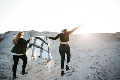 Two women with a scarf episodes in walking on the beach photos
